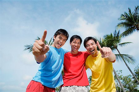 simsearch:656-01765786,k - Men with arms around each other, looking at camera, making hand sign Stock Photo - Premium Royalty-Free, Code: 656-01772834