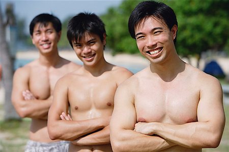 simsearch:656-01772853,k - Three shirtless men with arms crossed Fotografie stock - Premium Royalty-Free, Codice: 656-01772845