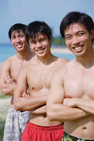 simsearch:656-01772843,k - Three men with arms crossed, in a row Fotografie stock - Premium Royalty-Free, Codice: 656-01772846