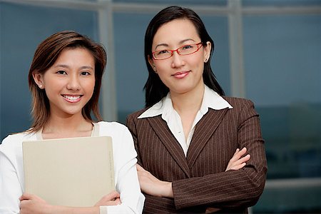 Two businesswomen standing side by side Stock Photo - Premium Royalty-Free, Code: 656-01772925