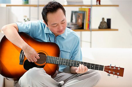 Man playing the guitar Stock Photo - Premium Royalty-Free, Code: 656-01773019