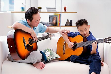 father playing guitar - Father teaching son to play the guitar Stock Photo - Premium Royalty-Free, Code: 656-01773020