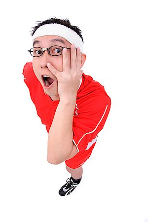 Man in soccer uniform looking at camera, hand on face Stock Photo - Premium Royalty-Free, Code: 656-01773063