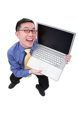 dorky businessman - Businessman with open laptop, looking at camera, smiling Stock Photo - Premium Royalty-Free, Code: 656-01773112