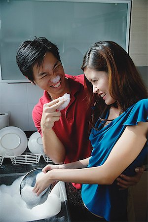 simsearch:656-01773586,k - Couple washing dishes, playing with soap suds Stock Photo - Premium Royalty-Free, Code: 656-01773471