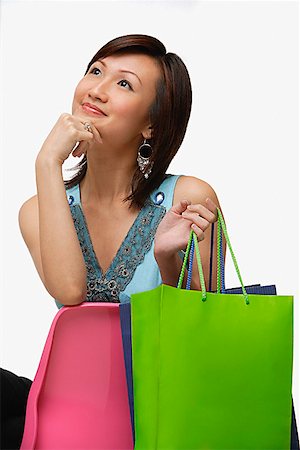 simsearch:656-01773308,k - Jeune femme avec shopping bags, regardant de loin, la main sur le menton Photographie de stock - Premium Libres de Droits, Code: 656-01773514