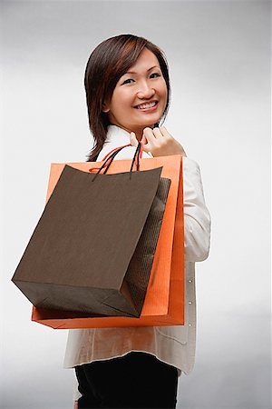 simsearch:656-01771655,k - Businesswoman with shopping bags, smiling Foto de stock - Sin royalties Premium, Código: 656-01773521