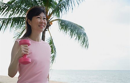 single coconut tree picture - Mature woman using dumbbell outdoors Stock Photo - Premium Royalty-Free, Code: 656-01773592