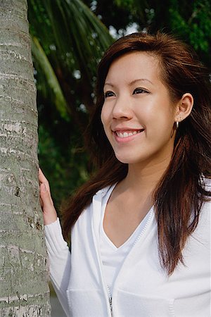 single coconut tree picture - Young woman looking away Stock Photo - Premium Royalty-Free, Code: 656-01773593