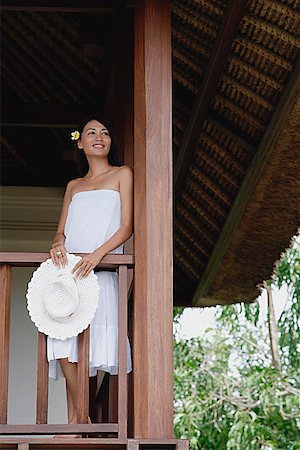 eurasian - Young woman standing in balcony, looking away Stock Photo - Premium Royalty-Free, Code: 656-01773778