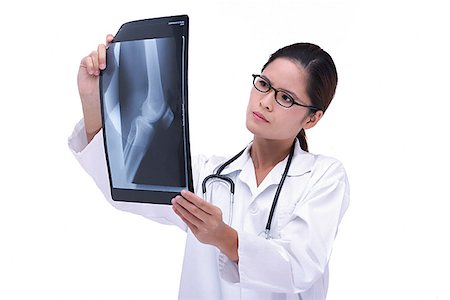 doctor looking at xray - Doctor studying X-ray Stock Photo - Premium Royalty-Free, Code: 656-01773813