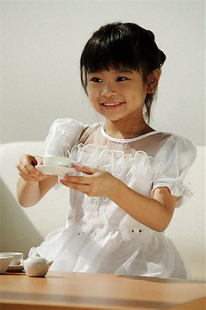 simsearch:656-01773586,k - Girl in white dress playing with tea cups Stock Photo - Premium Royalty-Free, Code: 656-01828849