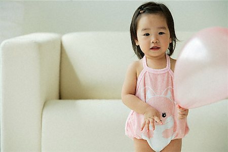 Baby girl with balloon Stock Photo - Premium Royalty-Free, Code: 656-01828917