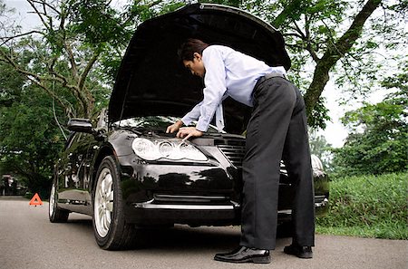 road to success - Businessman looking under hood of car Stock Photo - Premium Royalty-Free, Code: 656-02371650