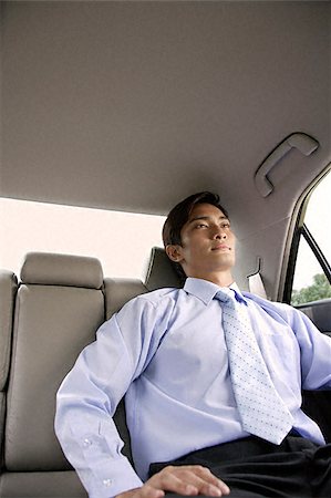 Businessman in backseat of car Stock Photo - Premium Royalty-Free, Code: 656-02371725