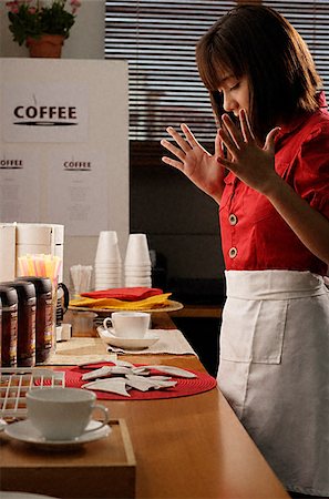 Waitress in diner with broken plate Stock Photo - Premium Royalty-Free, Code: 656-02371893