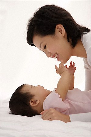 filipino girl - Woman playing with baby girl Stock Photo - Premium Royalty-Free, Code: 656-02660207