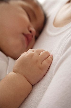baby girl sleeping against woman's chest Stock Photo - Premium Royalty-Free, Code: 656-02660203