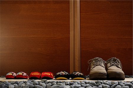 slippers and shoes placed in a row at door front Stock Photo - Premium Royalty-Free, Code: 656-02702807