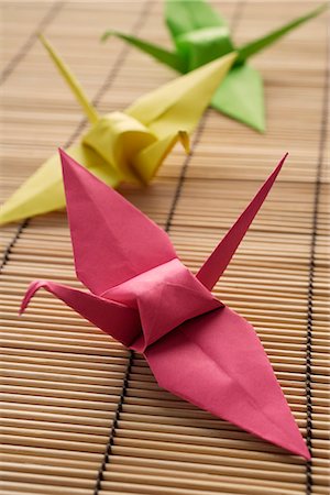 pink, yellow and green paper cranes Stock Photo - Premium Royalty-Free, Code: 656-02702850