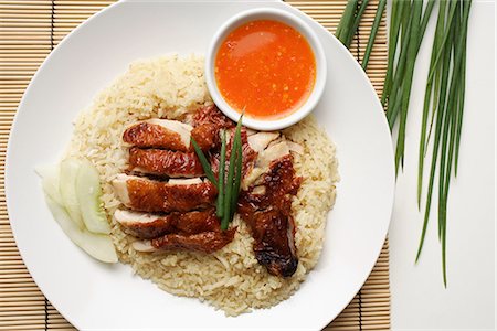 rice fried - chicken rice with chili sauce on the side on white plate Stock Photo - Premium Royalty-Free, Code: 656-02702863