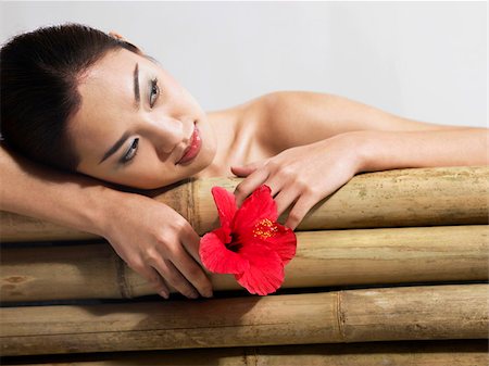 simsearch:695-05777385,k - woman relaxing with flower Stock Photo - Premium Royalty-Free, Code: 656-02879485