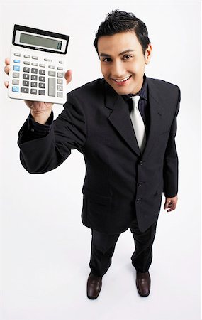 employee top view - man holding up calculator, smiling Stock Photo - Premium Royalty-Free, Code: 656-02879482