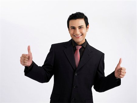 man making thumbs up hand signs smiling Foto de stock - Sin royalties Premium, Código: 656-02879504