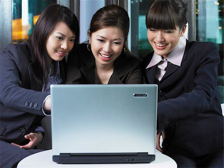 Three woman looking at laptop Stock Photo - Premium Royalty-Free, Code: 656-02879522