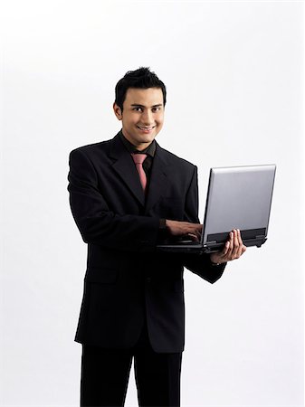 simsearch:656-02371640,k - man holding a laptop on one arm Foto de stock - Sin royalties Premium, Código: 656-02879534