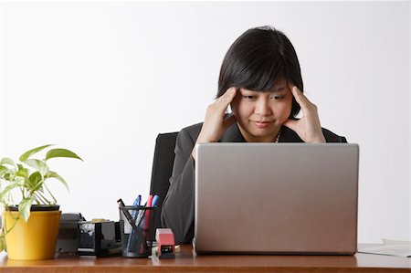 business woman looking stressed at computer Stock Photo - Premium Royalty-Free, Code: 656-02879566