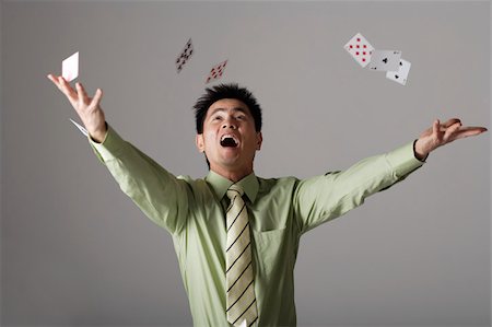 rich chinese woman - man throwing cards up into the air Stock Photo - Premium Royalty-Free, Code: 656-02879604