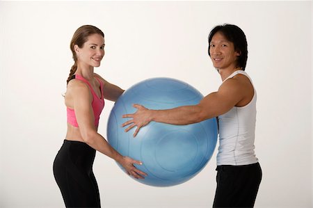 Couple working out with exercise ball Stock Photo - Premium Royalty-Free, Code: 656-02879634