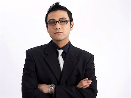 man wearing dark rimmed glasses, arms crossed Stock Photo - Premium Royalty-Free, Code: 656-02879635