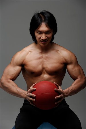 Man holding medicine ball Stock Photo - Premium Royalty-Free, Code: 656-02879648