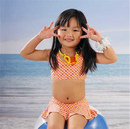 girl smiling at camera in bathing suit Stock Photo - Premium Royalty-Free, Code: 656-02879715
