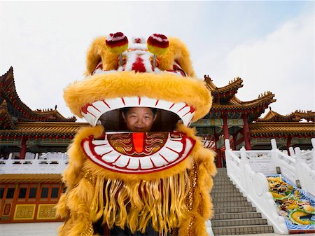 little boy inside of Chinese lion dance costume Stock Photo - Premium Royalty-Free, Code: 656-02879716