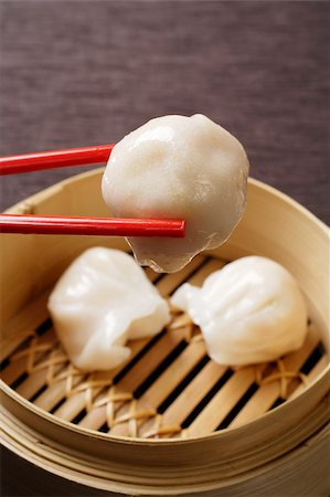 dim sum - red chopsticks holding dimsum Stock Photo - Premium Royalty-Free, Code: 656-03076244