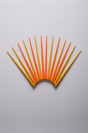 even - Orange and yellow chopsticks in the shape of a fan. Stock Photo - Premium Royalty-Free, Code: 656-03076247