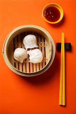 steaming basket - still life of dim sum in bamboo steamer with chopsticks Stock Photo - Premium Royalty-Free, Code: 656-03076258