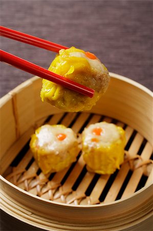 dimsum - red chopsticks holding dim sum Stock Photo - Premium Royalty-Free, Code: 656-03076330