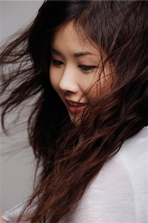 Head shot of Chinese woman with long hair Stock Photo - Premium Royalty-Free, Code: 656-03240980