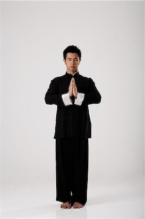 Man meditating wearing traditional Chinese clothes Stock Photo - Premium Royalty-Free, Code: 656-03240994