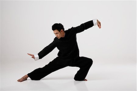 Man doing Tai Chi wearing traditional Chinese clothes Stock Photo - Premium Royalty-Free, Code: 656-03241037