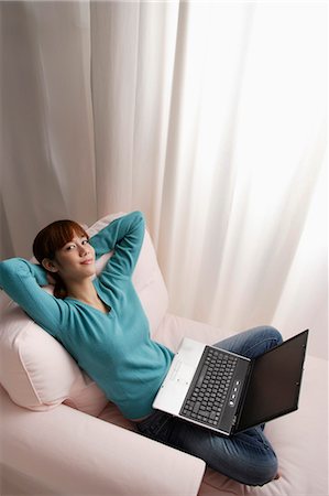 Asian girl relaxing at home with laptop Stock Photo - Premium Royalty-Free, Code: 656-03241049