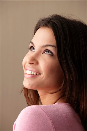 exotic - head shot of young woman looking up and smiling Stock Photo - Premium Royalty-Free, Code: 656-03519497