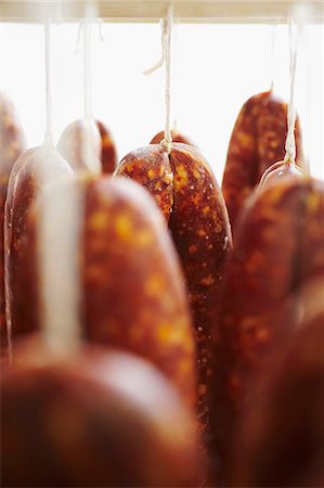 raw sausage - Curing Meat Hanging from Racks Stock Photo - Premium Royalty-Free, Code: 659-06154252