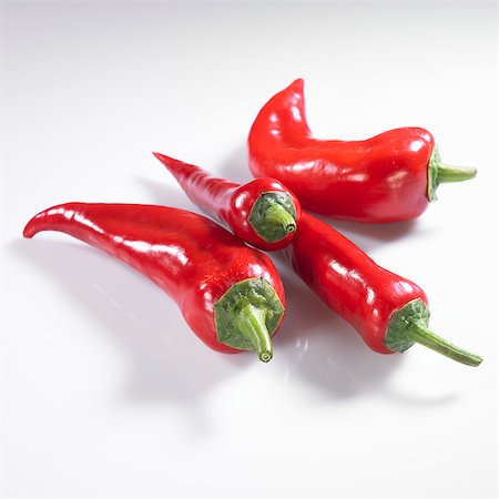 simsearch:659-06153207,k - Four red pointed peppers Stock Photo - Premium Royalty-Free, Code: 659-06154323