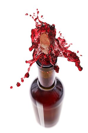 squirting - Red wine spraying out of a bottle Stock Photo - Premium Royalty-Free, Code: 659-06154354