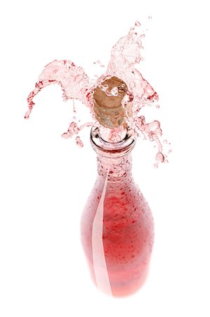 Rose wine spraying out of a bottle Stock Photo - Premium Royalty-Free, Code: 659-06154350